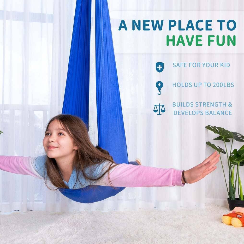 Smiling girl using a blue sensory swing hammock indoors, arms outstretched, with fun and safety benefits listed.