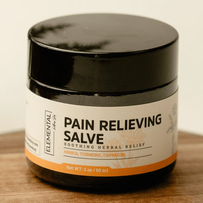 Jar of pain relieving salve with arnica, turmeric, and capsaicin for natural herbal relief