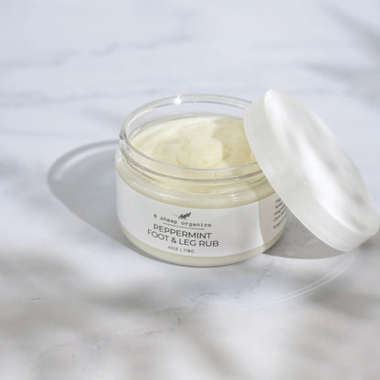 8 Sheep Organics Peppermint Foot & Leg Rub cream jar on light marble surface