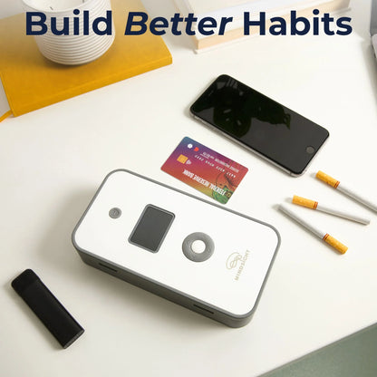 Personal timed lock box with phone, cigarettes, and credit card on desk for habit control