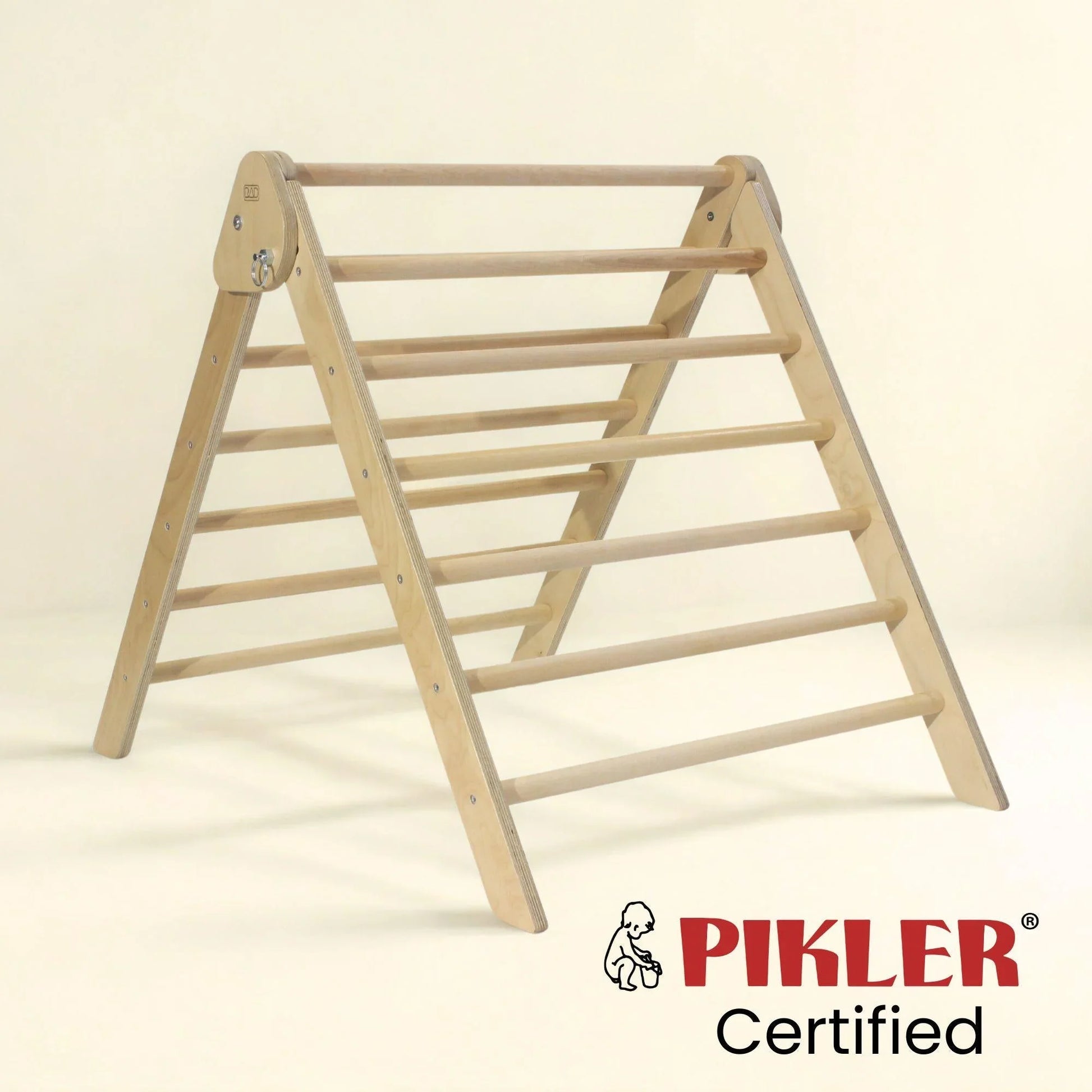 Wooden Pikler triangle climbing frame on a neutral background, certified for sensory play.