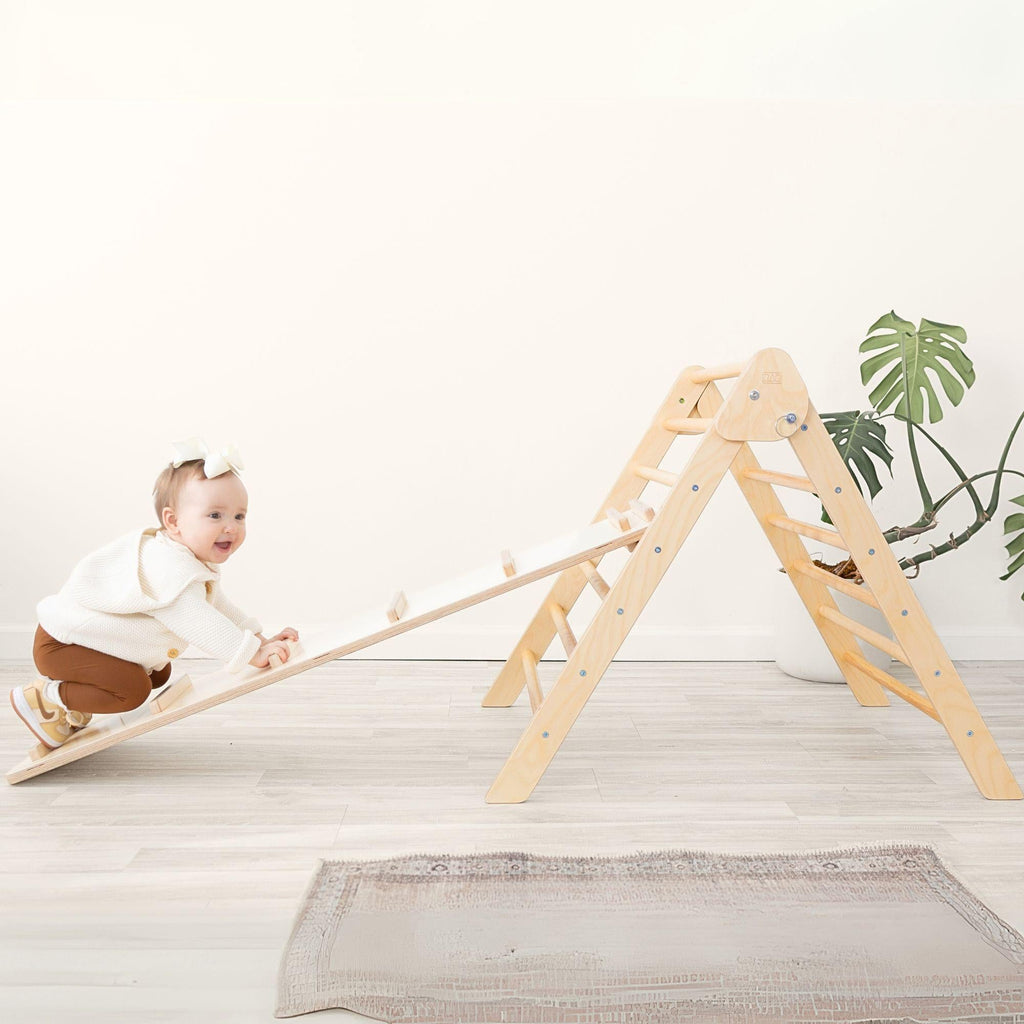 Child playing with a wooden climbing toy indoors