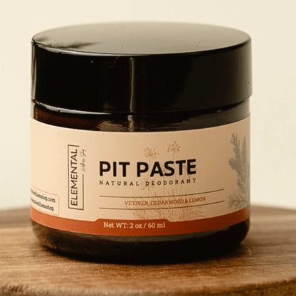 Natural deodorant pit paste jar with cedarwood, vetiver, and lemon on wooden surface