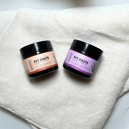 Two Elemental Wellness Pit Paste all natural deodorant jars on a white towel