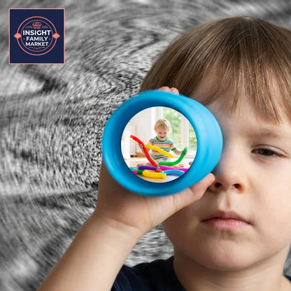 Child looking through blue sensory tube, colorful sensory toys visible, focus on play and learning.