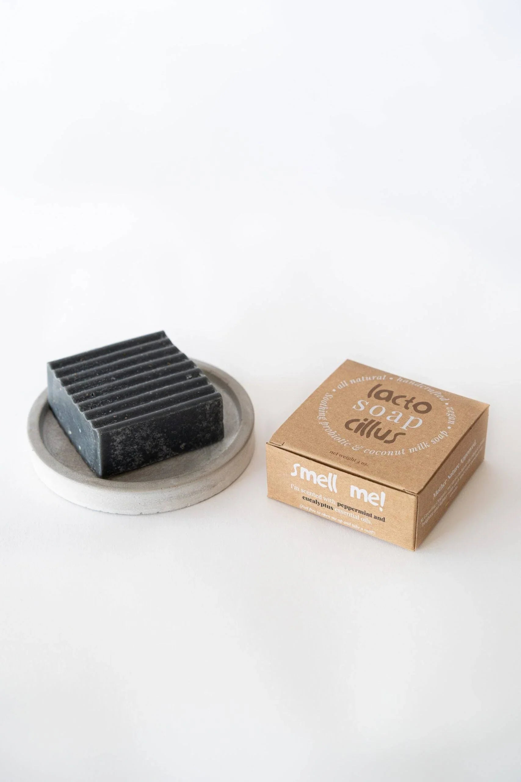 Peppermint eucalyptus probiotic bar soap on dish beside eco-friendly box, natural ingredients.