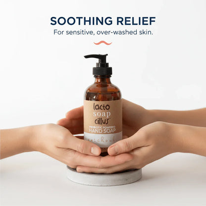 Hands holding a probiotic powered hand soap bottle for sensitive skin