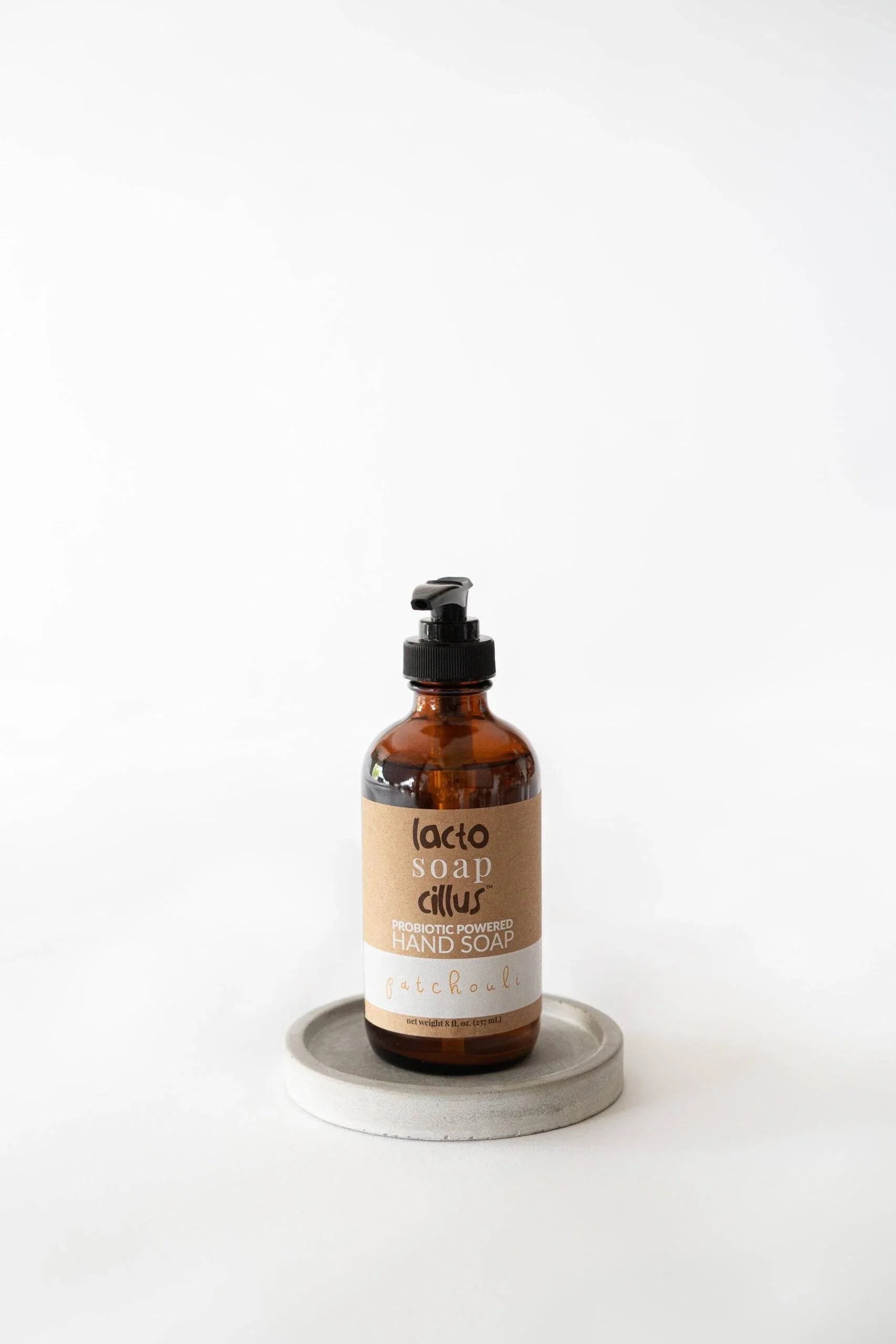 Amber pump bottle of hand soap on a white surface