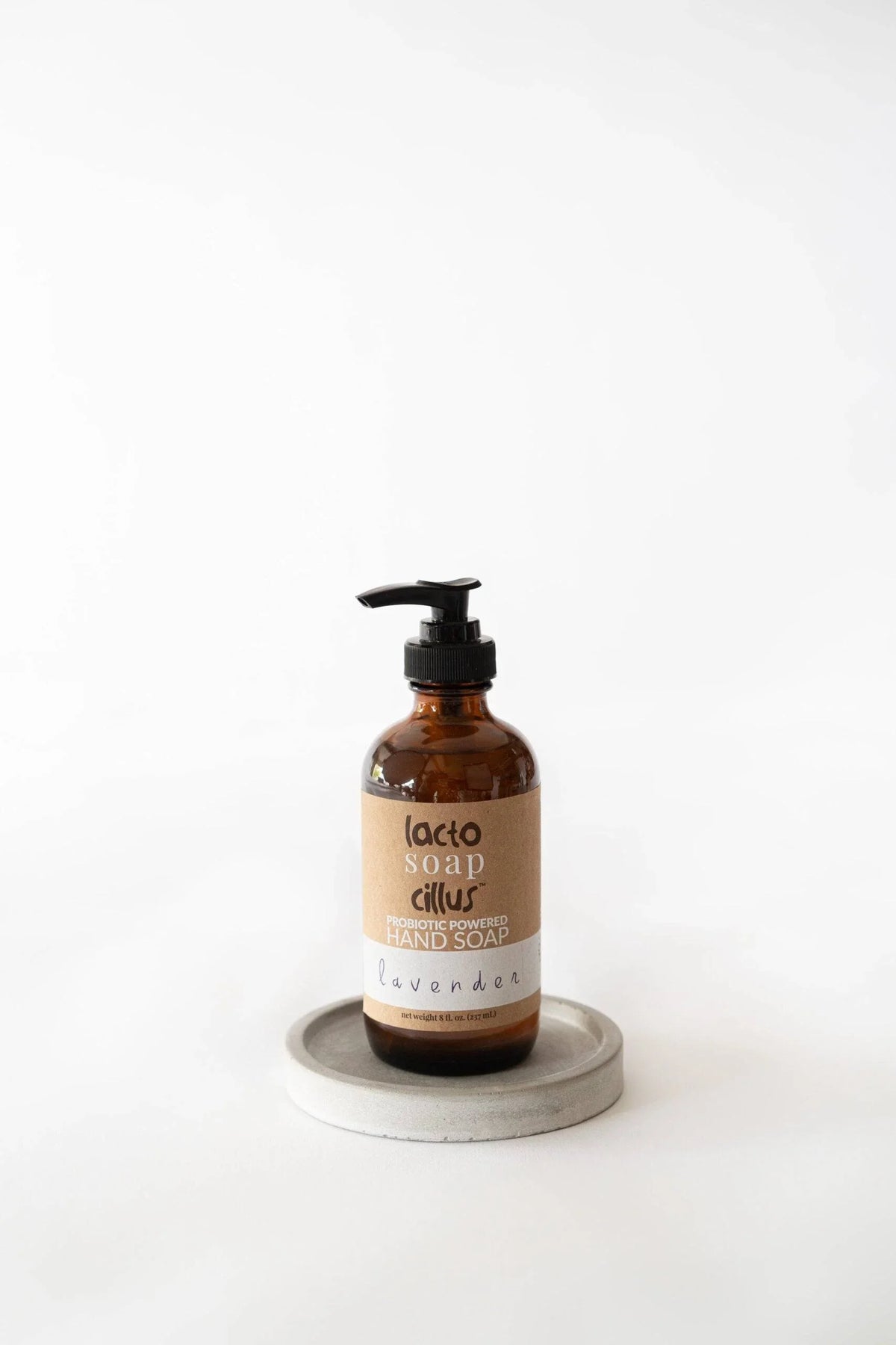Lavender liquid hand soap vwith a minimalist brown label on a bright surface.