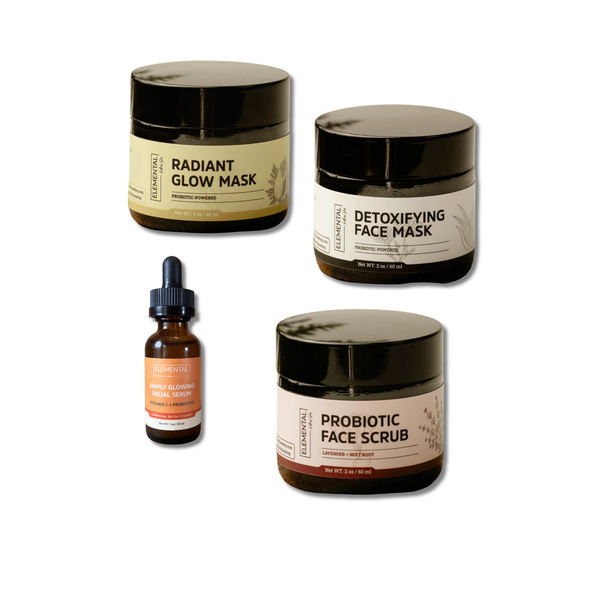 Set of facial skincare products including jars and a dropper bottle on a white background