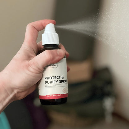 Hand spraying natural protect and purify immune support spray in home environment