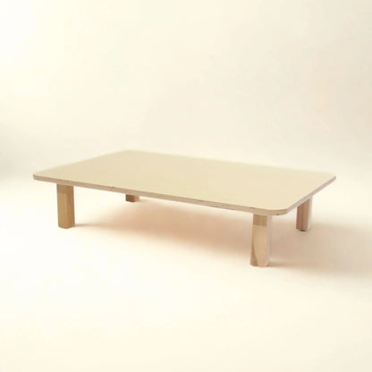 Rectangular wooden infant table with rounded corners and short legs, neutral background