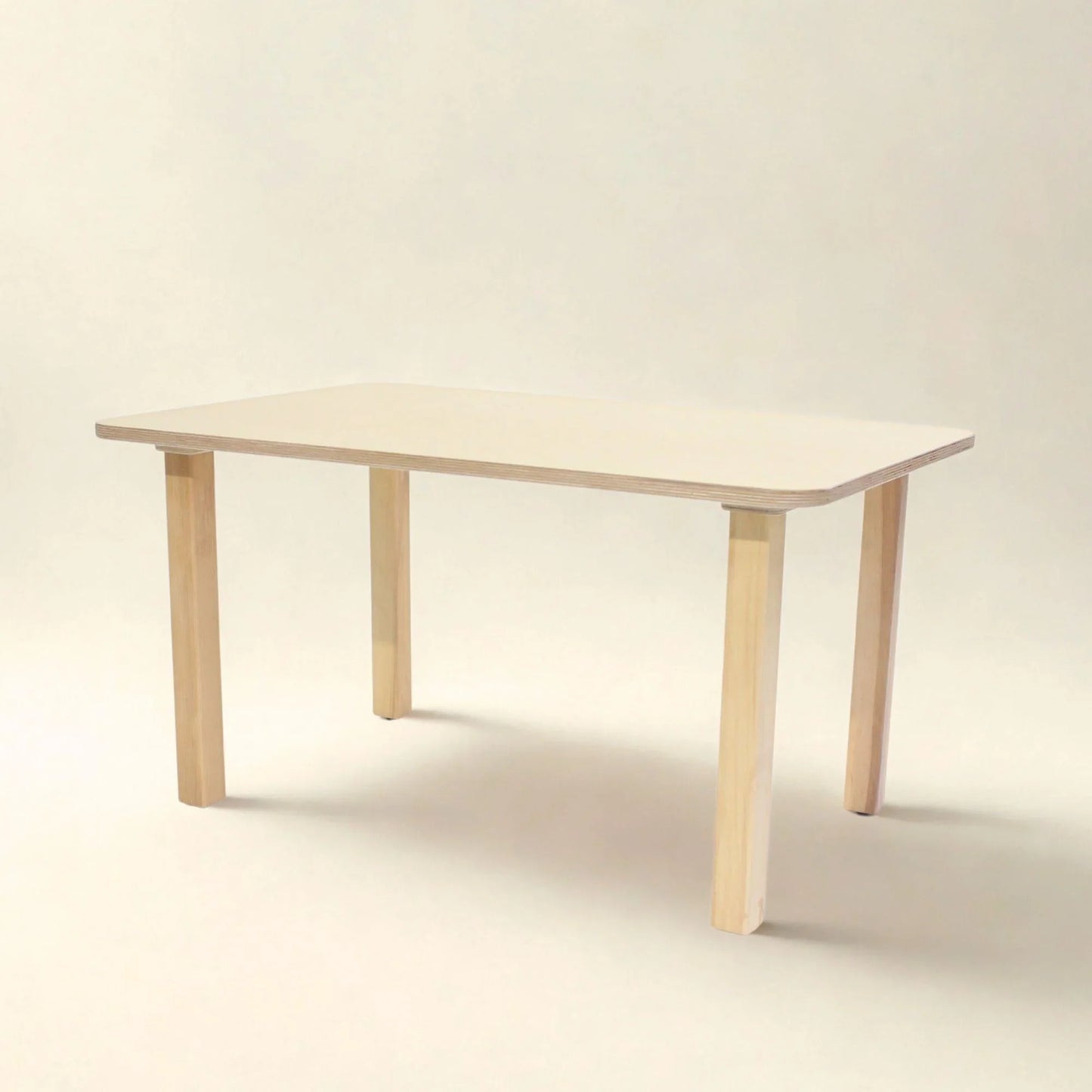 Rectangular preschool table with light wood legs and smooth beige top, classroom furniture