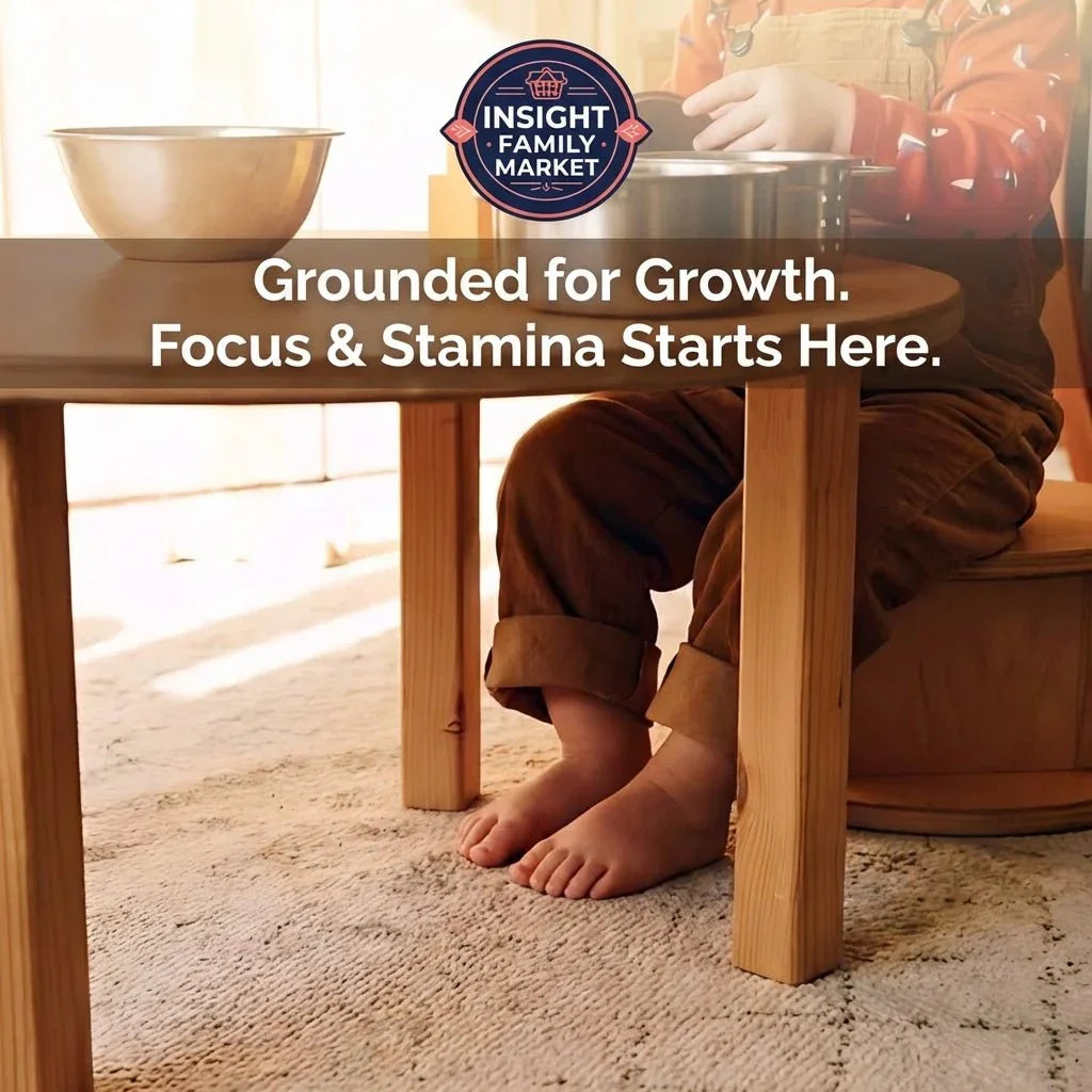 Child in brown overalls sitting barefoot at wooden table, promoting focus and sensory tools.