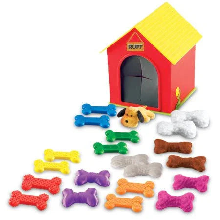 Colorful tactile dog bones and plush dog toy with red doghouse, sensory sorting game