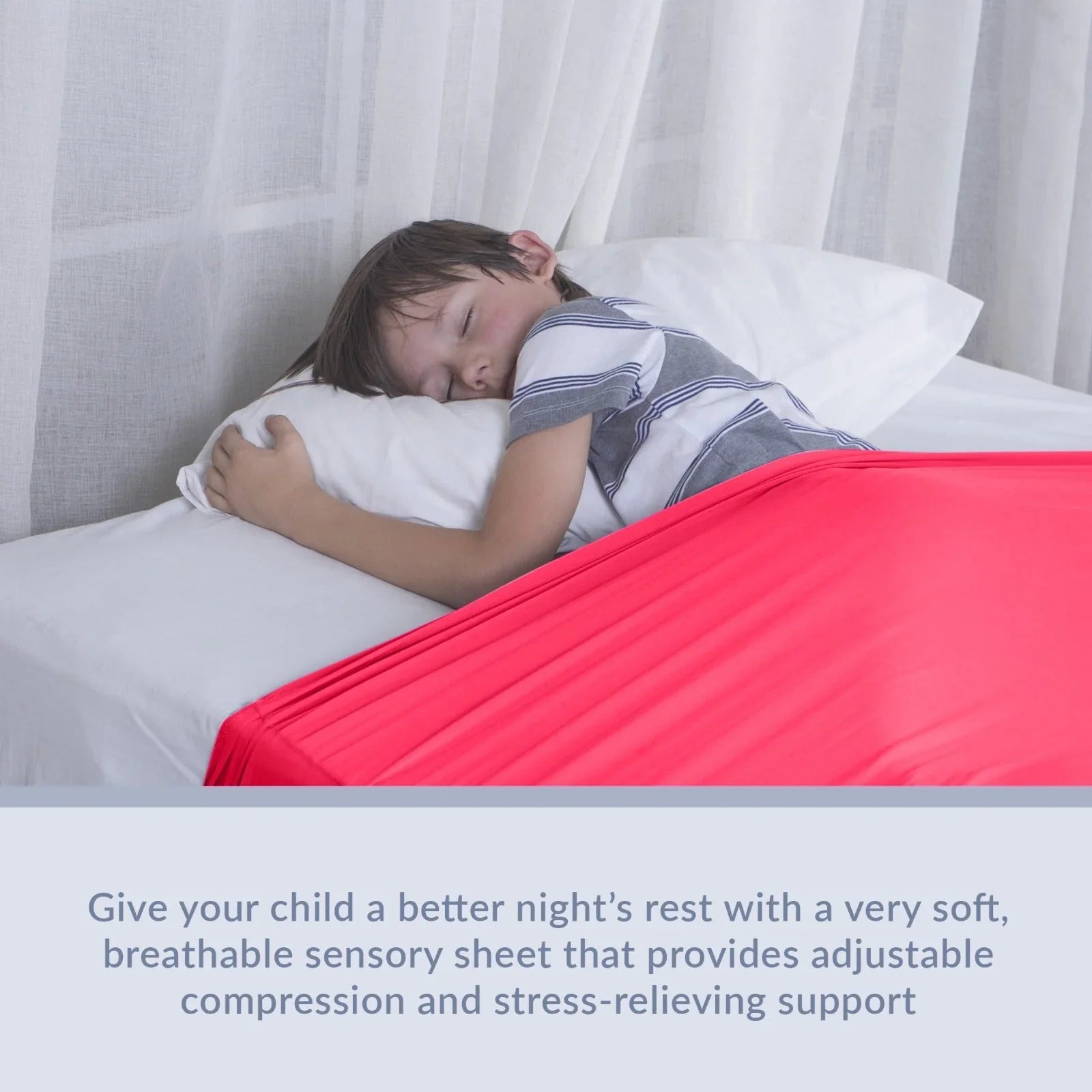 Child sleeping under soft red sensory compression sheet on bed, ideal for sensory support