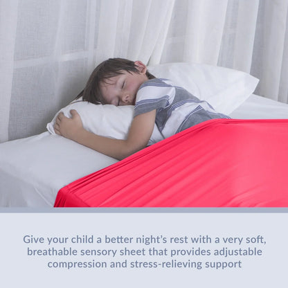 Child sleeping under soft red sensory compression sheet on bed, ideal for sensory support