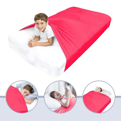 Child using red sensory compression sheet on bed for calming, sleep support, sensory needs
