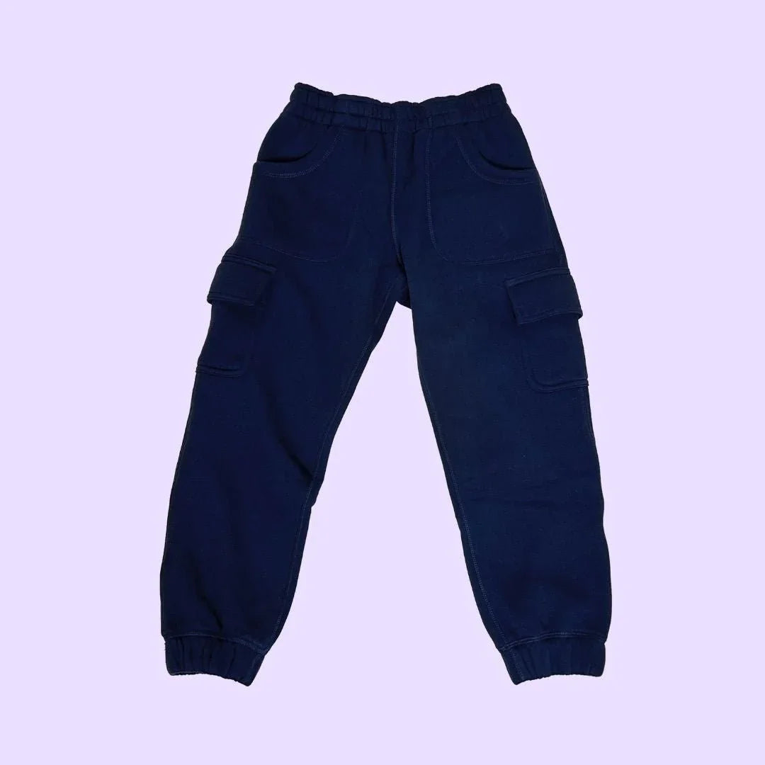 Navy blue sensory-friendly kids cargo jogger pants with pockets on a light purple background