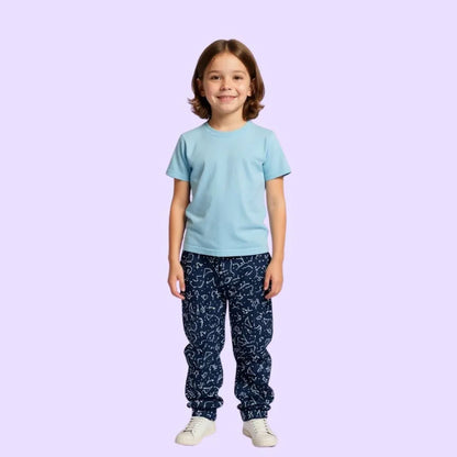 Smiling child in sensory-friendly blue t-shirt and navy patterned pants for kids