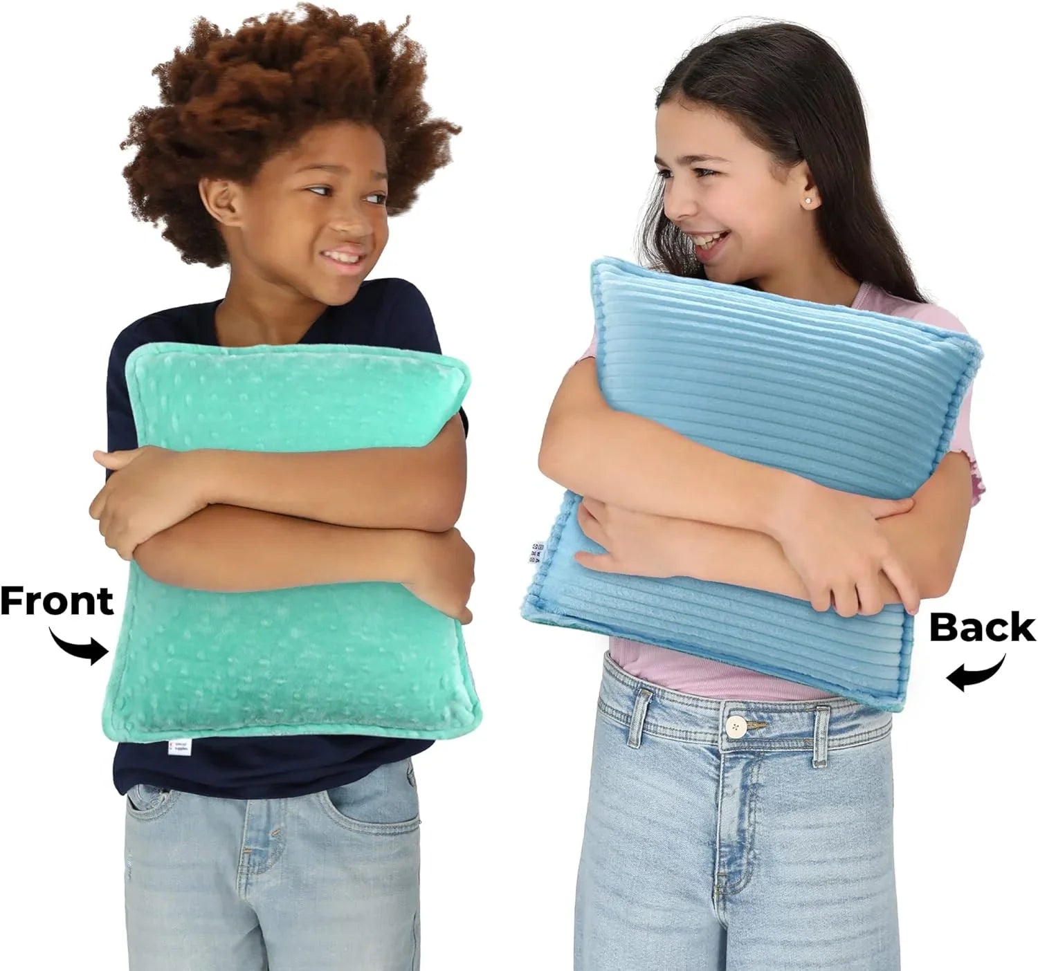 Two children hugging sensory-friendly pillows, one with a mint green dot texture front, one with a blue ribbed back.