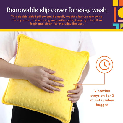 Person hugging yellow sensory pillow with removable cover and vibration feature for calming support