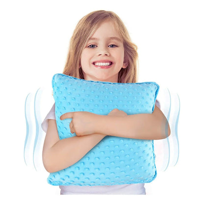 Smiling child hugging a textured blue sensory pillow, sensory-friendly support for kids