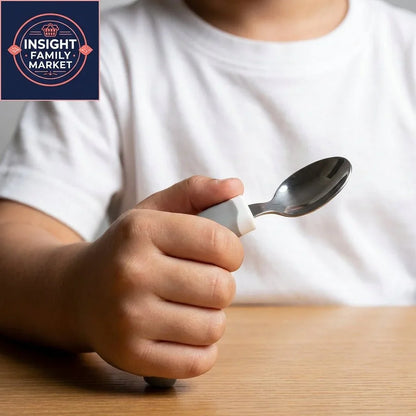 Child holding adaptive spoon with easy-grip handle at table, sensory-friendly utensil