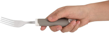 Hand holding a gray ergonomic adaptive fork with non-slip handle