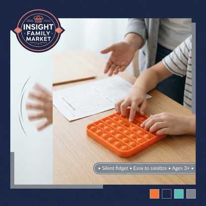 Child using orange silicone sensory fidget toy at desk, helpful for focus and calming energy.