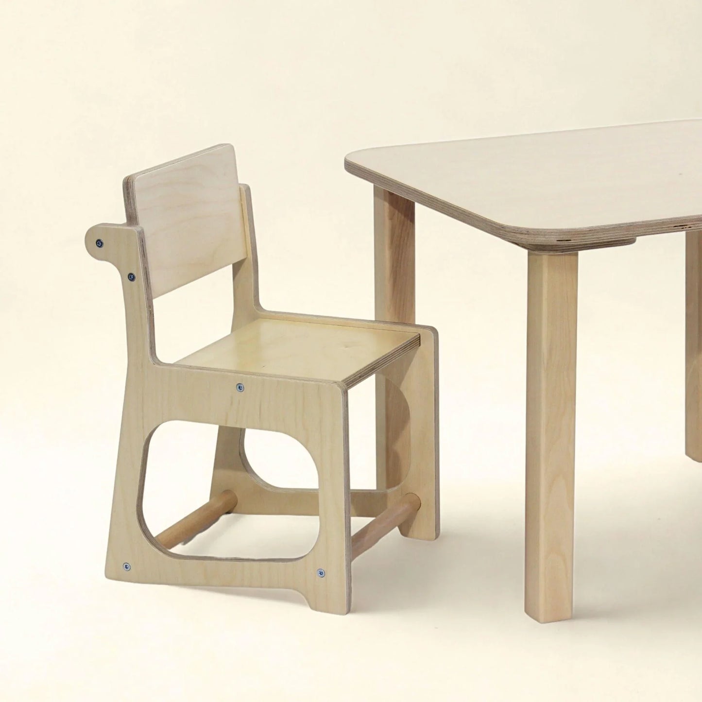 Natural wood sensory-friendly kids chair and table set on a neutral background