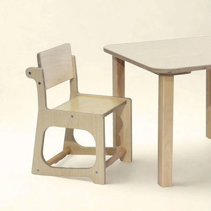 Natural wood sensory-friendly kids chair and table set on a neutral background