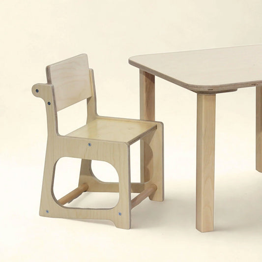 Natural wood sensory-friendly kids chair and table set on a neutral background