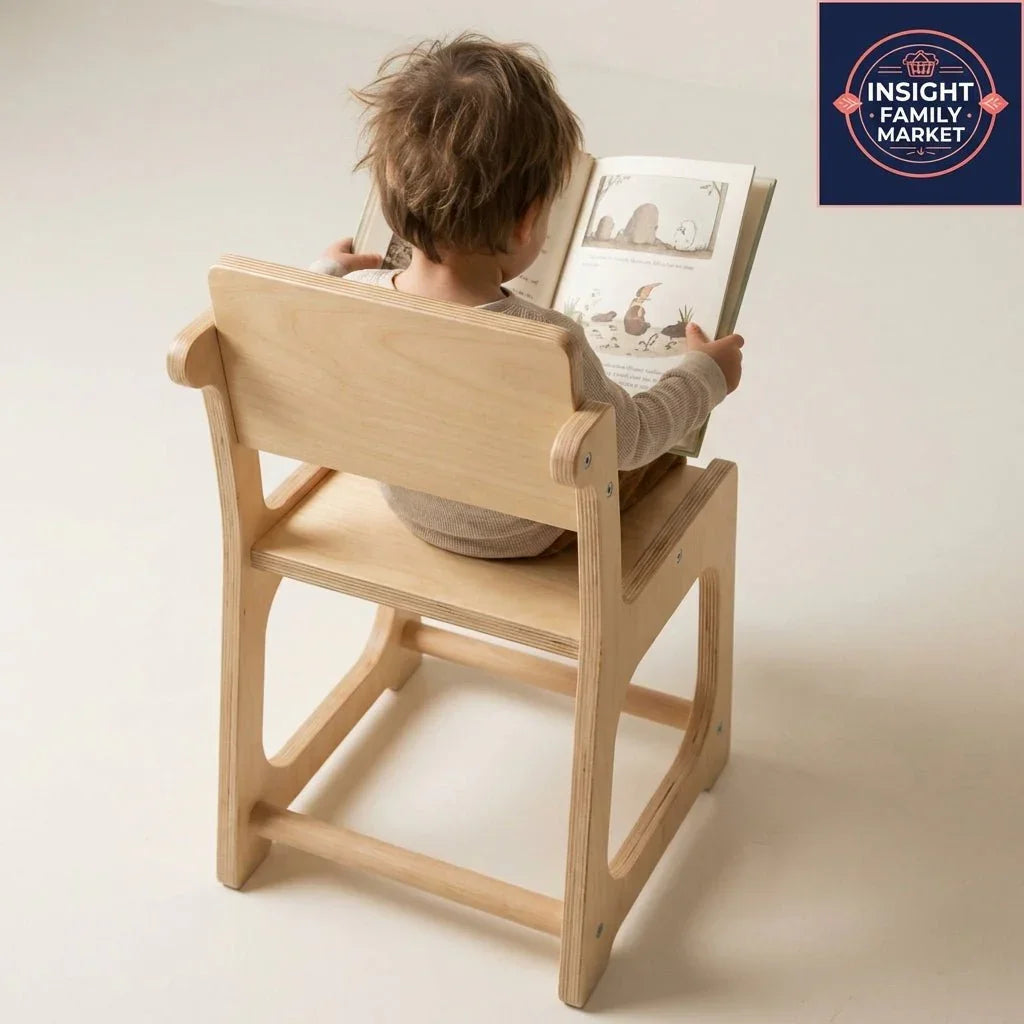 Young child sitting on a wooden chair reading a picture book, calm learning environment.