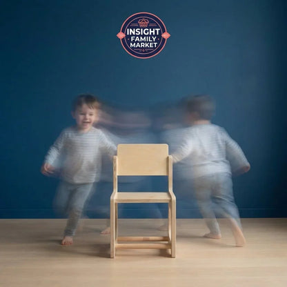 Active child in motion around a sensory-friendly wooden chair against blue wall