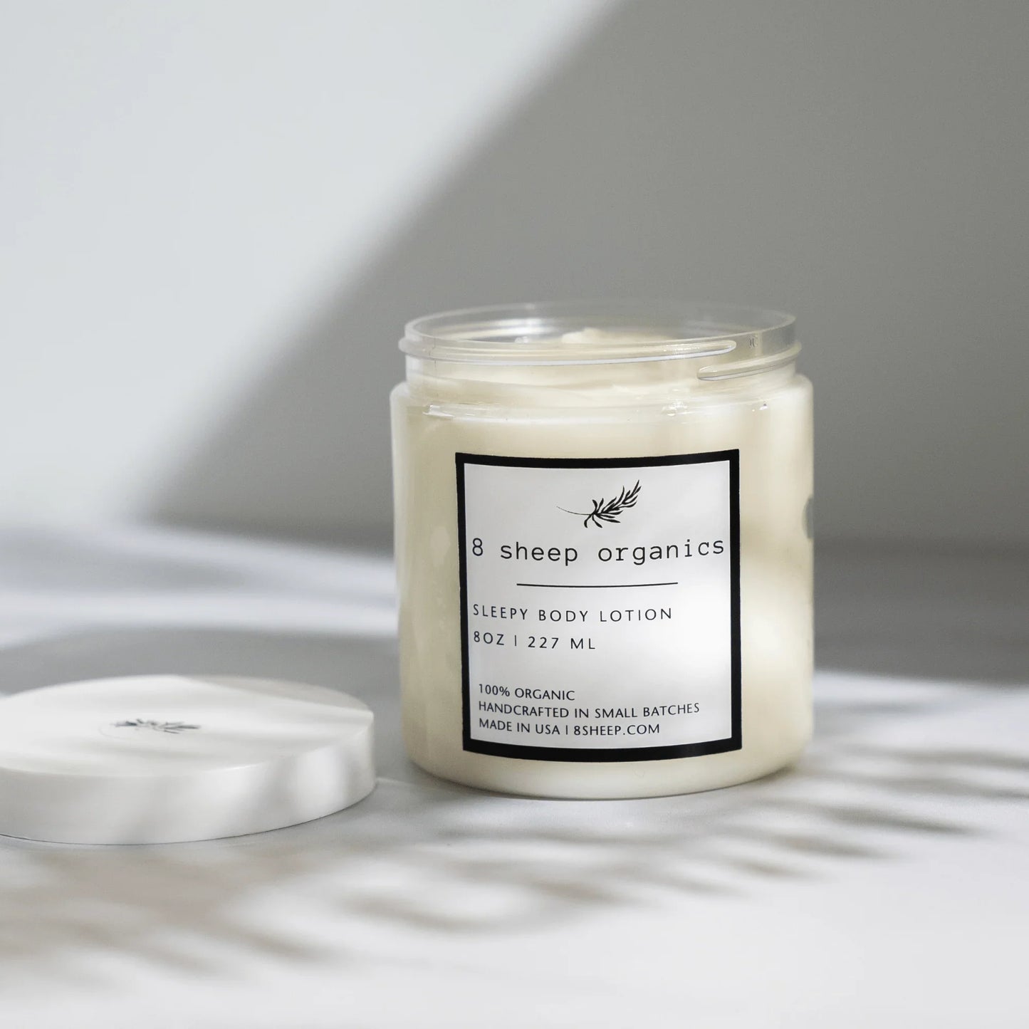8 Sheep Organics Sleepy Body Lotion jar on a white surface, organic skincare product