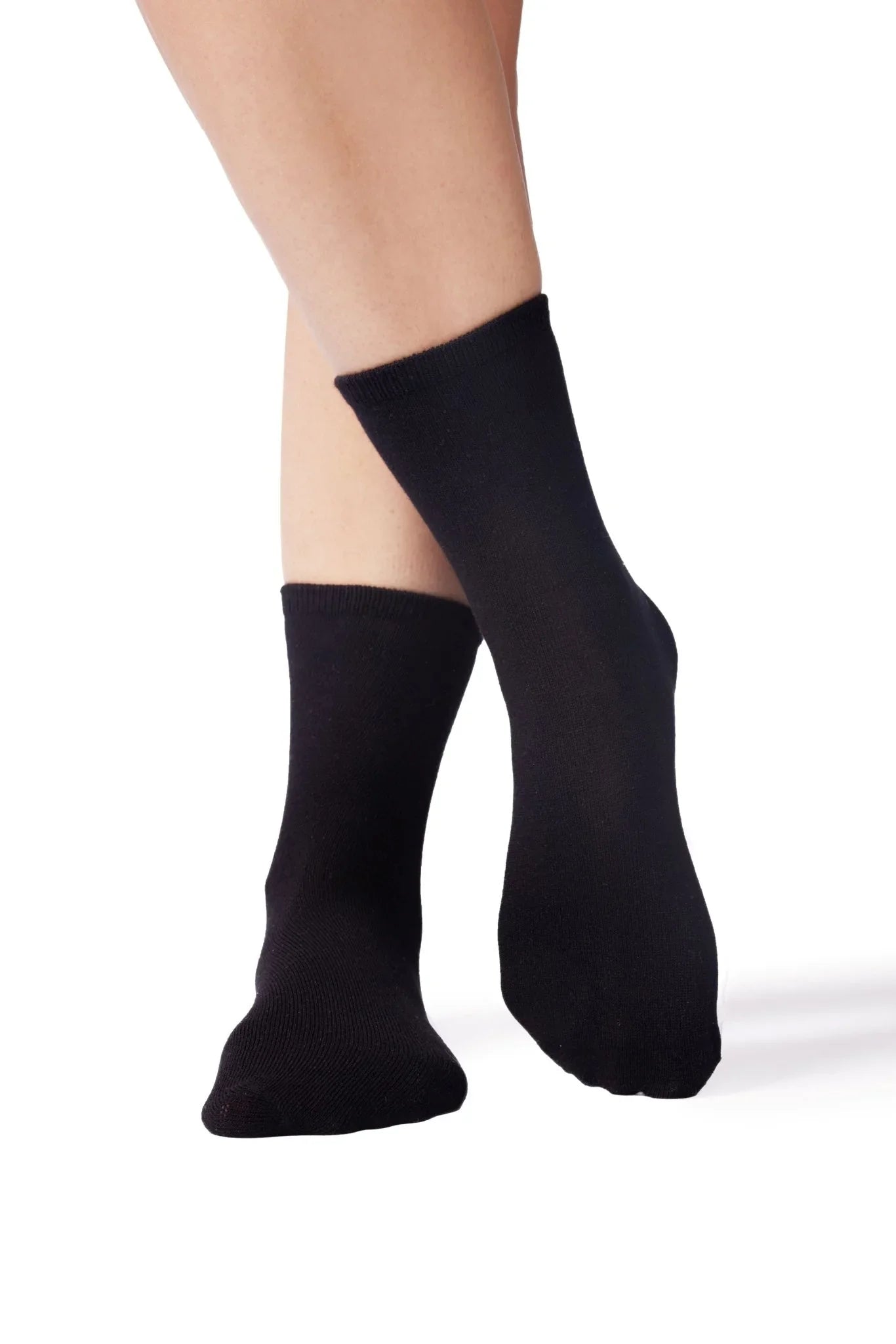 Black sensory-friendly crew socks on feet, ideal for sensitive skin and comfort