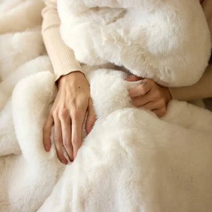 Hands wrapped in a cozy, fluffy vanilla-colored sensory-friendly blanket.