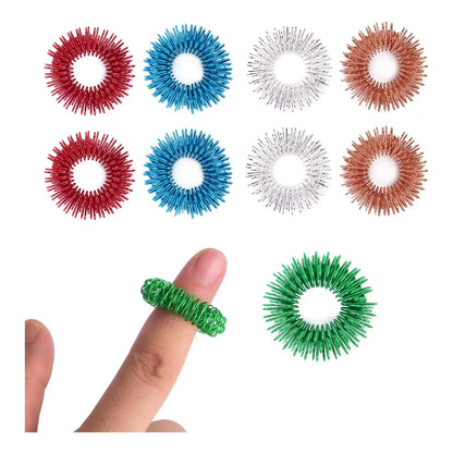 Colorful sensory acupressure rings for fidgeting, shown on a finger and arranged by color.