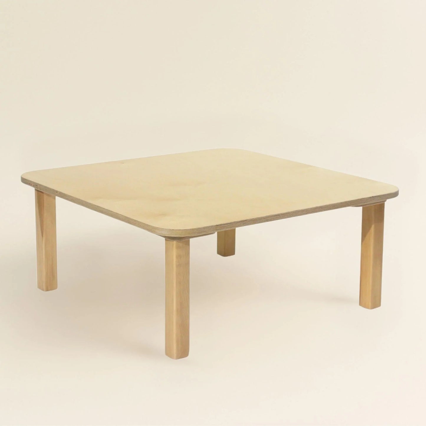 Square wooden toddler table with rounded edges on a neutral background