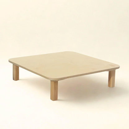 Minimalist square wooden sensory-friendly table with rounded corners on a neutral background