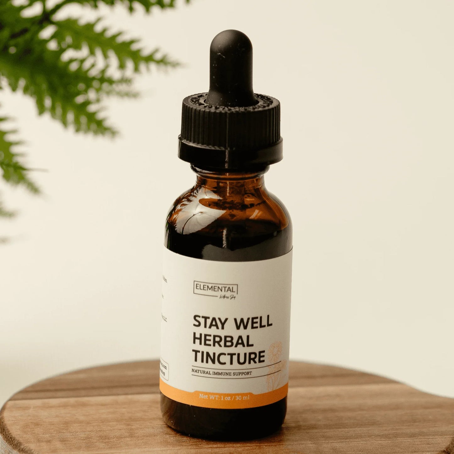 Stay Well Herbal Tincture bottle with dropper for natural immune support on wooden surface