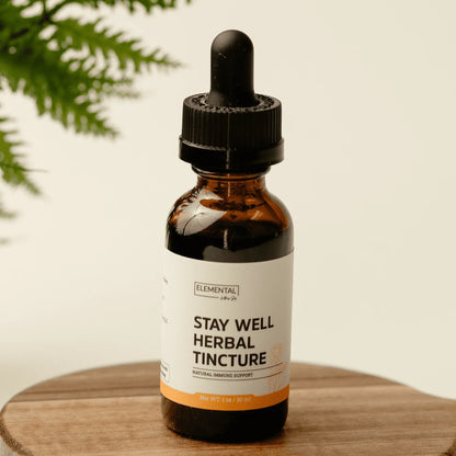Stay Well Herbal Tincture bottle with dropper for natural immune support on wooden surface