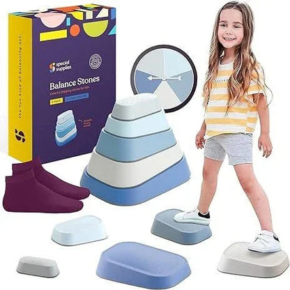 Child playing on blue and gray sensory balance stones, box and socks in background.