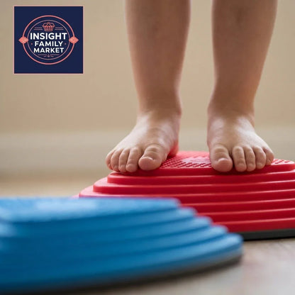Child's bare feet balancing on red sensory stepper, blue stepper in foreground, indoor setting.