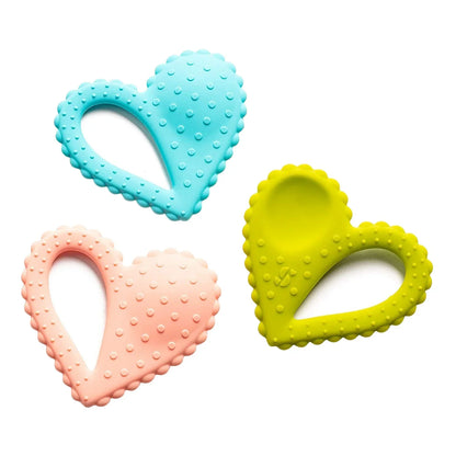Set of three heart-shaped sensory chew toys in blue, pink, and yellow with textured surfaces