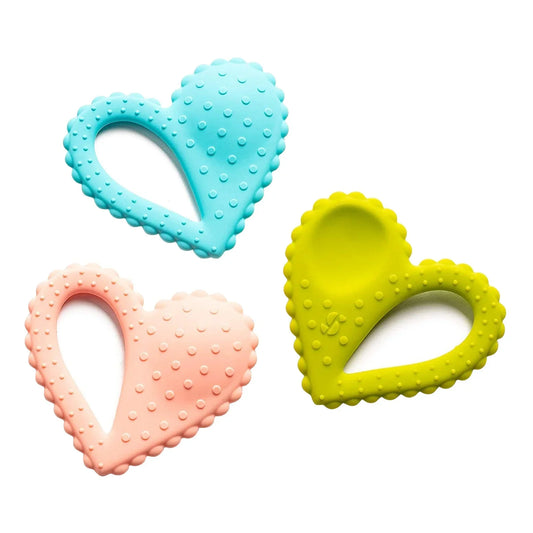 Set of three heart-shaped sensory chew toys in blue, pink, and yellow with textured surfaces