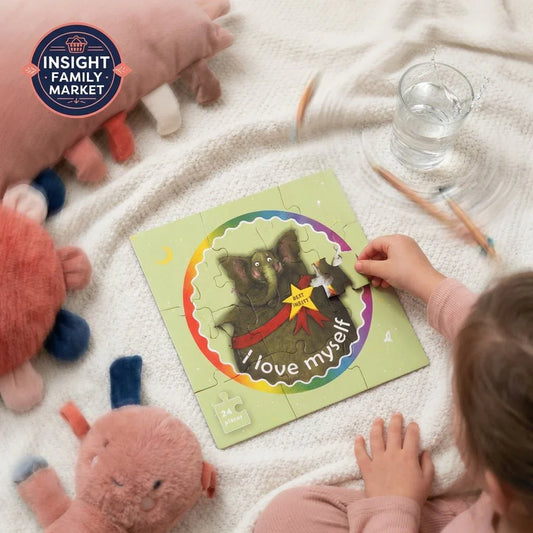 Child assembling sensory-friendly elephant puzzle with 'I love myself' positive message