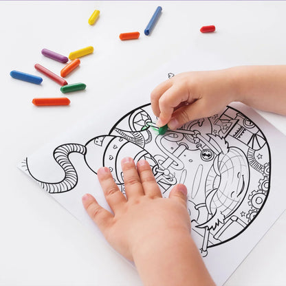 Child coloring robot-themed coloring page with colorful crayons on table