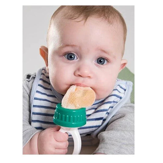 Baby using a mesh baby safe feeder, wearing striped bib, sensory-friendly feeding tool